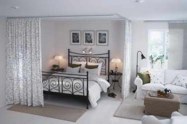 Sheer curtains on a runner give this bedroom a dreamy feel while maintaining some privacy.