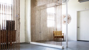 Hemp rope threaded and knotted through a wooden beam, or stretched in a frame, can divide a room while still letting light through. 